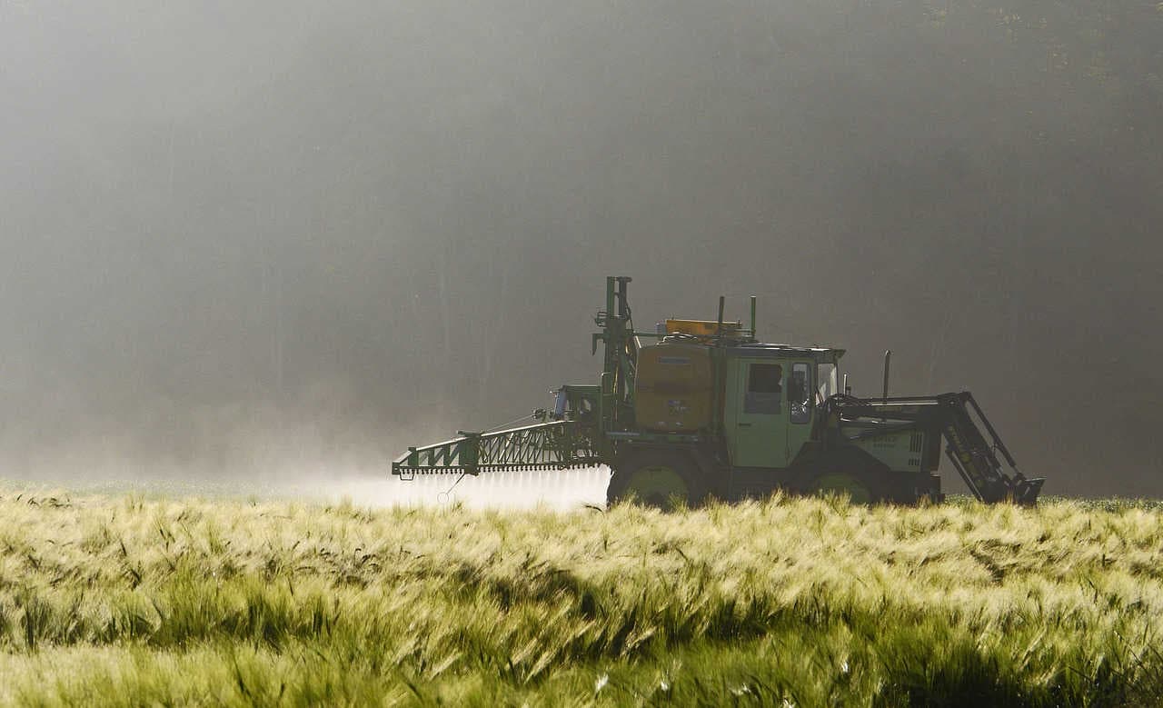 tractor applying pesticide onto field